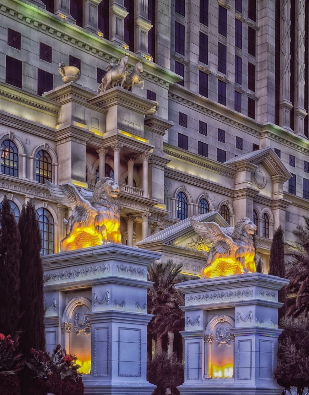 Interior of a luxury casino suite with a king bed and city view